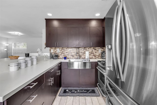 20000 SW 114th Ave, Miami, FL 33189 - kitchen featuring appliances with stainless steel finishes, light countertops, dark brown cabinetry, tasteful backsplash, and a peninsula