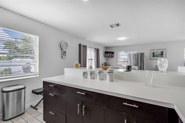 20000 SW 114th Ave, Miami, FL 33189 - kitchen featuring light countertops, freestanding refrigerator, light tile patterned flooring, and dark brown cabinets