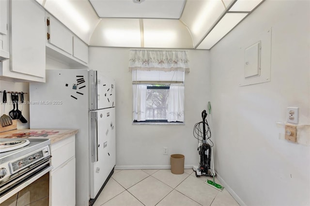 10304 Sunrise Lakes Blvd Unit 209, Sunrise, FL 33322 - kitchen featuring stainless steel electric range, light tile patterned flooring, light countertops, white cabinetry, and freestanding refrigerator
