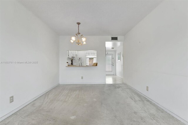 10304 Sunrise Lakes Blvd Unit 209, Sunrise, FL 33322 - unfurnished living room with a chandelier and light colored carpet