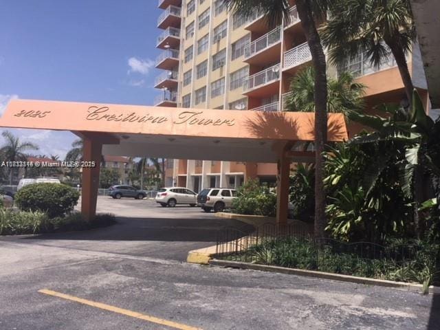 2025 NE 164th St Unit 516, North Miami Beach, FL 33162 - view of apartment building / complex featuring uncovered parking