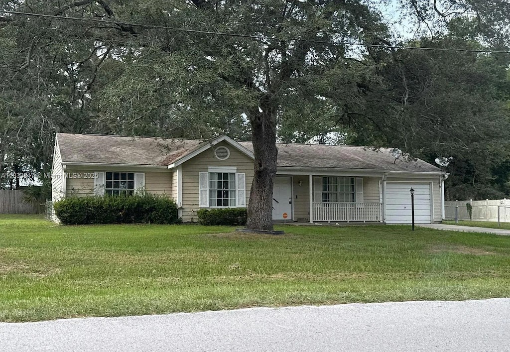 25 Cedar Trce, Ocala, FL 34472 - ranch-style house featuring a garage, covered porch, and driveway