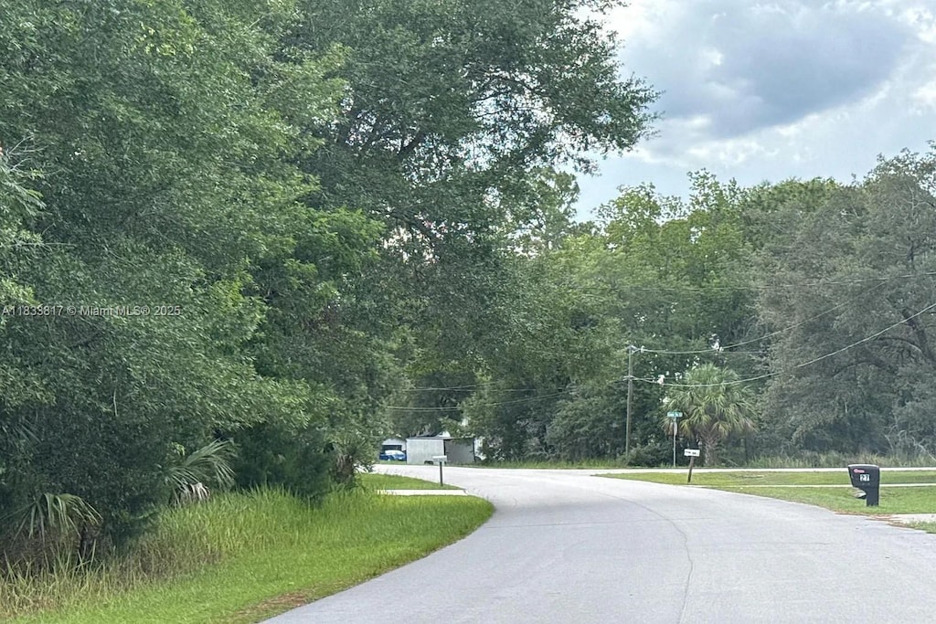 25 Cedar Trce, Ocala, FL 34472 - view of asphalt road with a view of trees