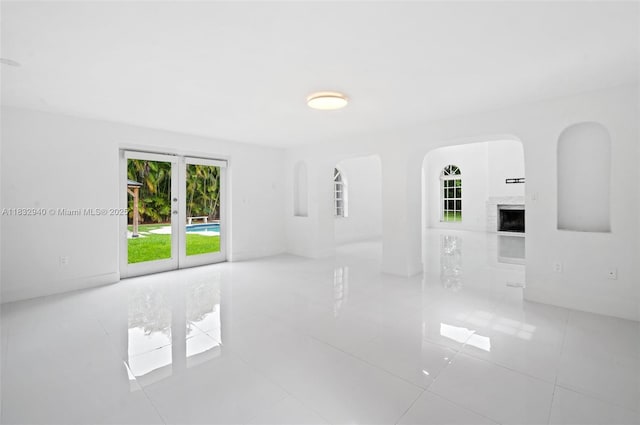 8250 SW 187th St, Cutler Bay, FL 33157 - tiled empty room with a high end fireplace and arched walkways