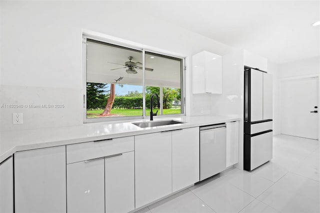 8250 SW 187th St, Cutler Bay, FL 33157 - kitchen featuring stainless steel dishwasher, freestanding refrigerator, white cabinetry, modern cabinets, and light countertops