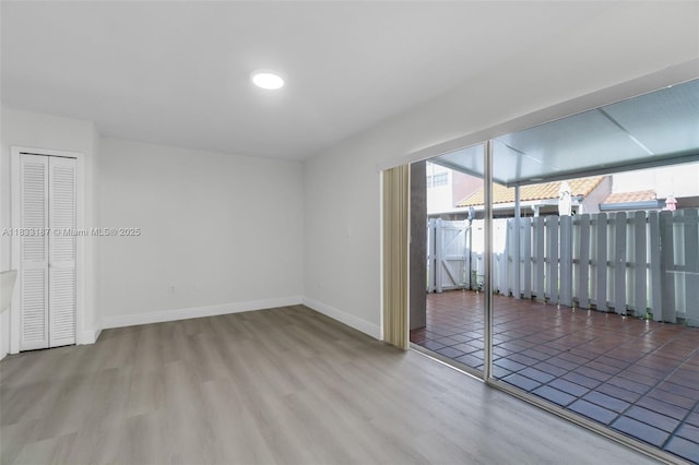 6514 SW 128th Pl Unit 6514, Miami, FL 33183 - empty room featuring healthy amount of natural light and wood finished floors