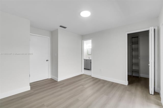 6514 SW 128th Pl Unit 6514, Miami, FL 33183 - unfurnished bedroom with light wood-style flooring, a walk in closet, a closet, and ensuite bathroom