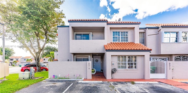 6514 SW 128th Pl Unit 6514, Miami, FL 33183 - mediterranean / spanish-style house featuring stucco siding, a tile roof, uncovered parking, and a gate