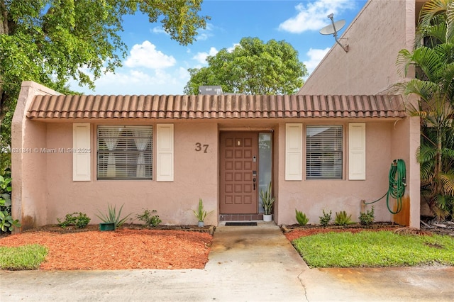 37 Seville Cir Unit 1-50, Davie, FL 33324 - view of front facade with a tiled roof and stucco siding