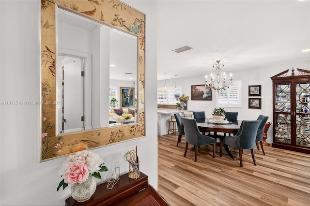 240 NE 97th St, Miami Shores, FL 33138 - dining space featuring wood finished floors and a chandelier