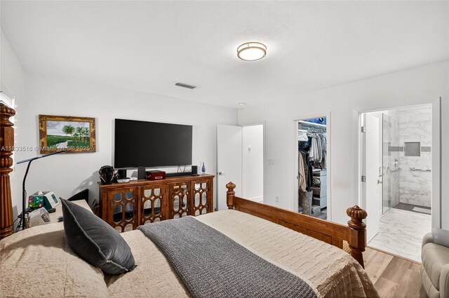 240 NE 97th St, Miami Shores, FL 33138 - bedroom with a walk in closet, a closet, ensuite bathroom, and light wood-style floors