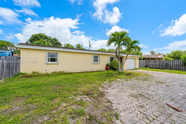 2727 Hypoluxo Rd, Boynton Beach, FL 33462 - view of front of house with decorative driveway, an attached garage, and brick siding
