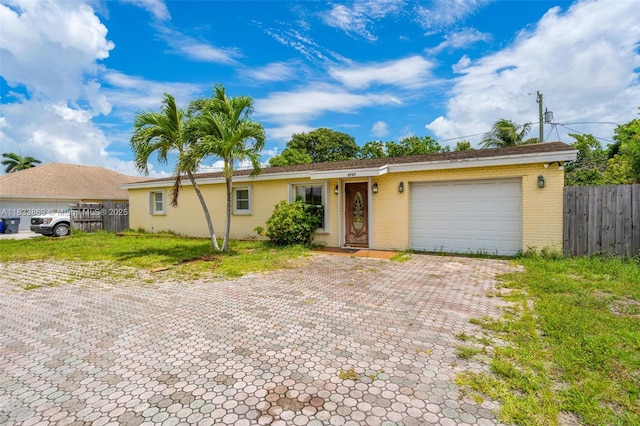 2727 Hypoluxo Rd, Boynton Beach, FL 33462 - ranch-style house with a garage, decorative driveway, and brick siding
