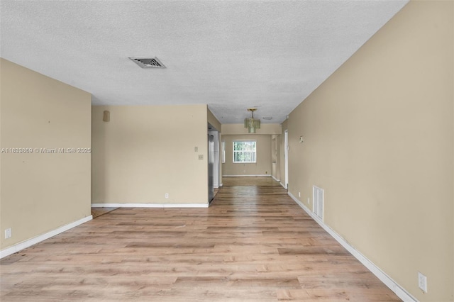 2727 Hypoluxo Rd, Boynton Beach, FL 33462 - unfurnished room with light wood finished floors and a textured ceiling