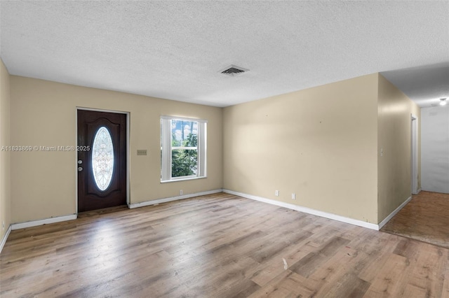 2727 Hypoluxo Rd, Boynton Beach, FL 33462 - foyer entrance featuring wood finished floors and a textured ceiling