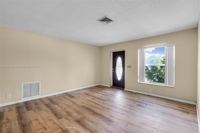 2727 Hypoluxo Rd, Boynton Beach, FL 33462 - entrance foyer with wood finished floors and a textured ceiling