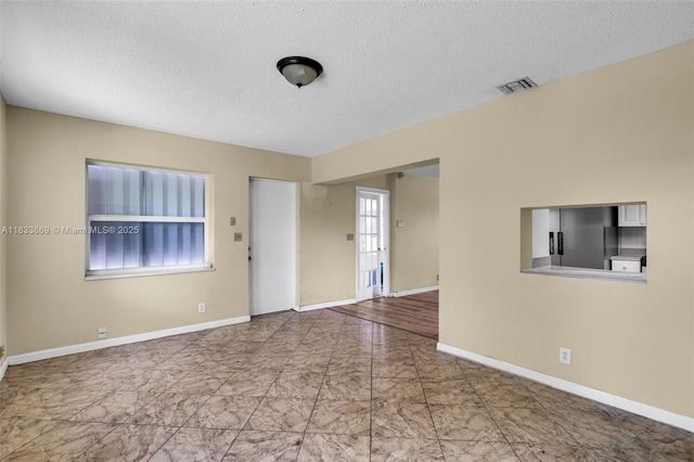 2727 Hypoluxo Rd, Boynton Beach, FL 33462 - unfurnished room with a textured ceiling and marble finish flooring