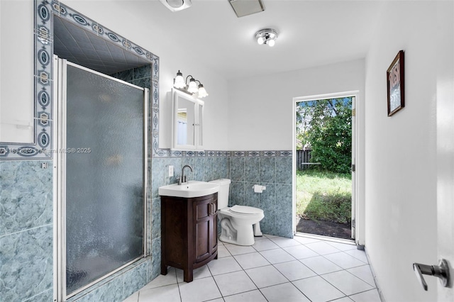 2727 Hypoluxo Rd, Boynton Beach, FL 33462 - bathroom featuring tile walls, vanity, tile patterned floors, a shower stall, and wainscoting
