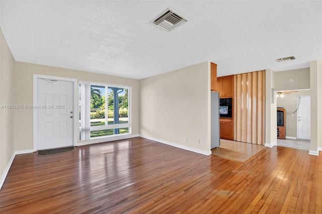 4061 Nova Ln, Lake Worth, FL 33462 - unfurnished living room with light wood finished floors, a textured ceiling, and ceiling fan