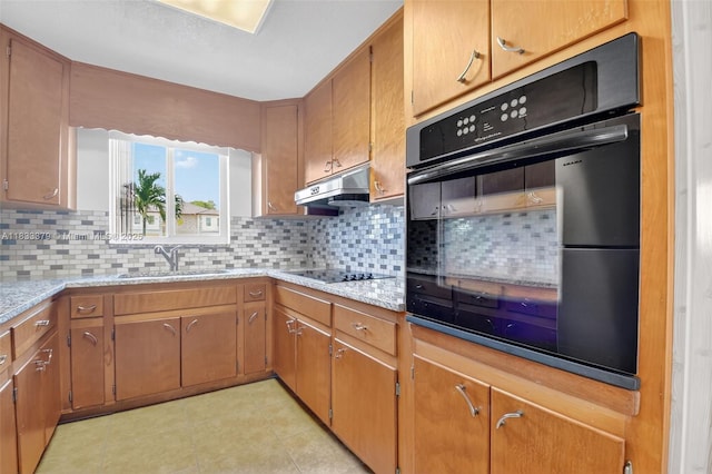 4061 Nova Ln, Lake Worth, FL 33462 - kitchen featuring black appliances, light tile patterned floors, backsplash, and brown cabinets