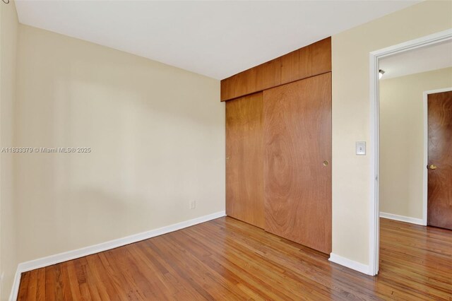 4061 Nova Ln, Lake Worth, FL 33462 - unfurnished bedroom featuring wood finished floors and a closet