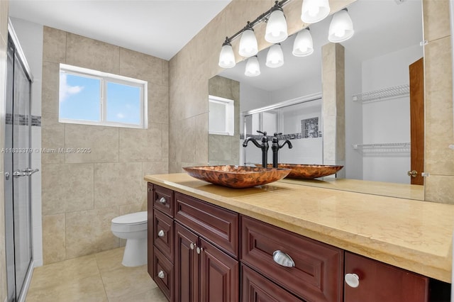 4061 Nova Ln, Lake Worth, FL 33462 - bathroom featuring tile patterned flooring, a stall shower, vanity, and tile walls
