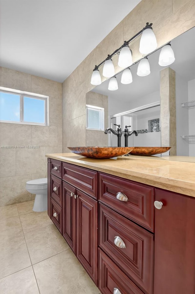 4061 Nova Ln, Lake Worth, FL 33462 - bathroom with tile walls, tile patterned flooring, vanity, and a shower with shower door