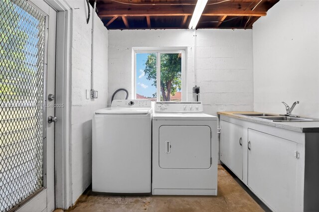 4061 Nova Ln, Lake Worth, FL 33462 - laundry room featuring washing machine and dryer, cabinet space, and concrete block wall