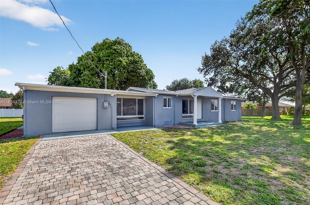 4061 Nova Ln, Lake Worth, FL 33462 - ranch-style house featuring stucco siding, a garage, and decorative driveway