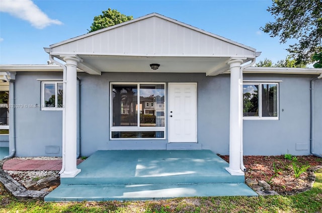 4061 Nova Ln, Lake Worth, FL 33462 - doorway to property with stucco siding and covered porch