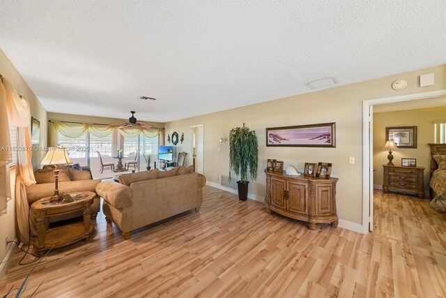 841 Meadowlark Ln, Delray Beach, FL 33445 - living room featuring light wood-type flooring, a textured ceiling, and a ceiling fan