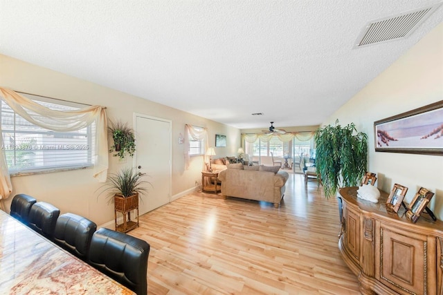 841 Meadowlark Ln, Delray Beach, FL 33445 - living area featuring light wood-type flooring, a textured ceiling, and a ceiling fan