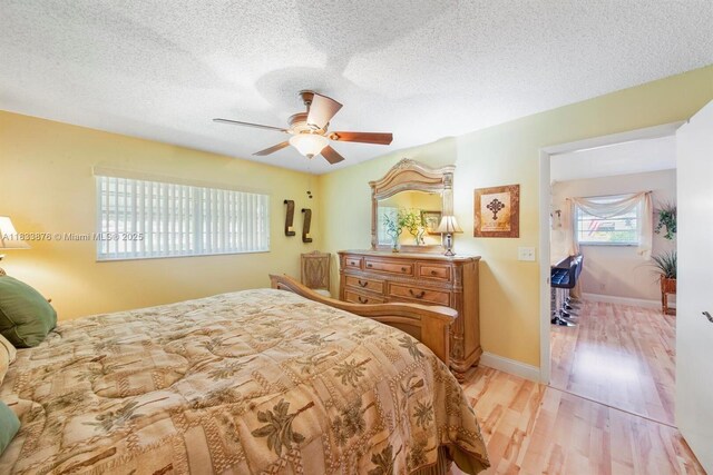 841 Meadowlark Ln, Delray Beach, FL 33445 - bedroom featuring light wood-style flooring, a textured ceiling, and ceiling fan