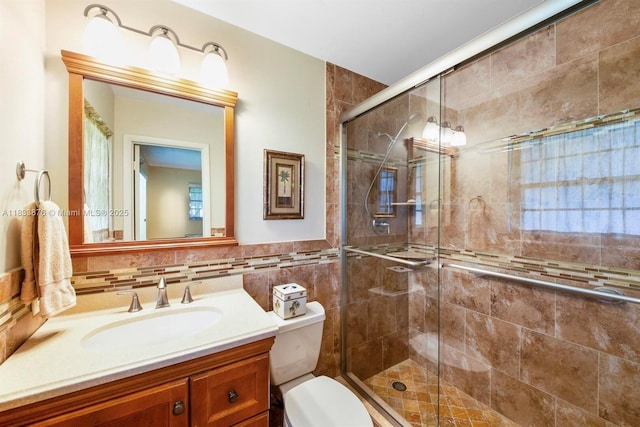 841 Meadowlark Ln, Delray Beach, FL 33445 - bathroom featuring vanity, a stall shower, tile walls, and a wainscoted wall