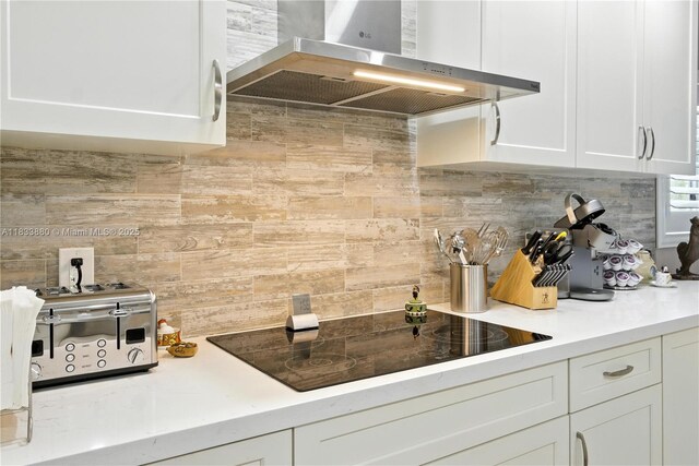 1651 SW 127th Ave Unit 301A, Pembroke Pines, FL 33027 - kitchen with wall chimney exhaust hood, tasteful backsplash, black electric stovetop, and white cabinets