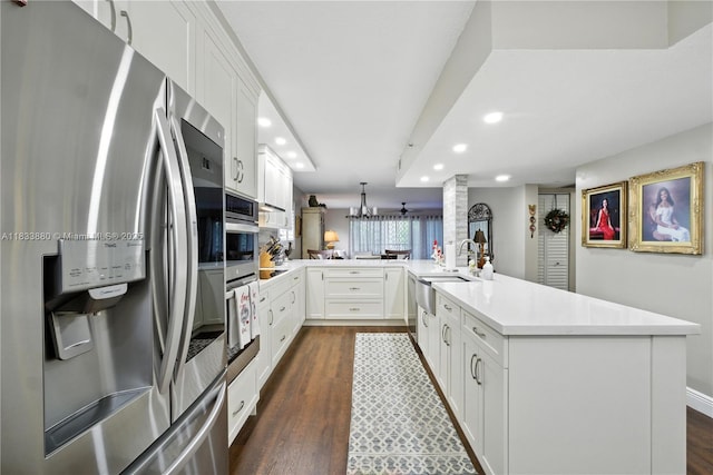 1651 SW 127th Ave Unit 301A, Pembroke Pines, FL 33027 - kitchen with appliances with stainless steel finishes, recessed lighting, a peninsula, dark wood-type flooring, and light countertops
