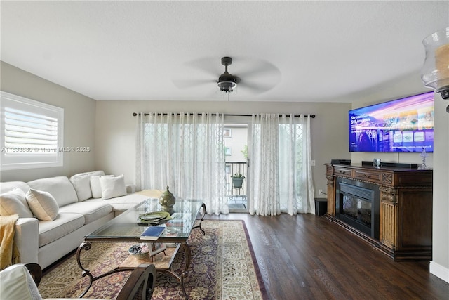 1651 SW 127th Ave Unit 301A, Pembroke Pines, FL 33027 - living room featuring dark wood finished floors, ceiling fan, and a glass covered fireplace