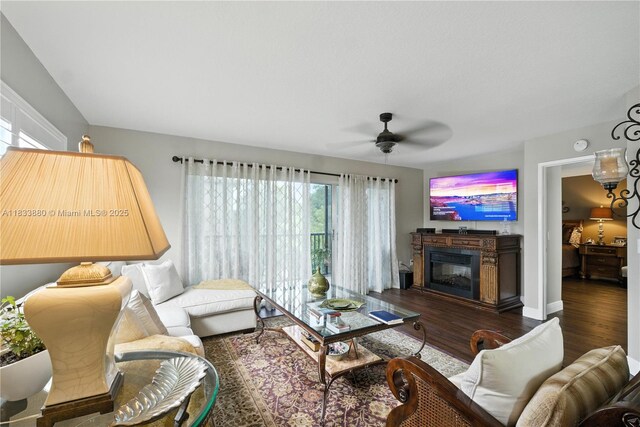 1651 SW 127th Ave Unit 301A, Pembroke Pines, FL 33027 - living area featuring wood finished floors, a ceiling fan, and a glass covered fireplace