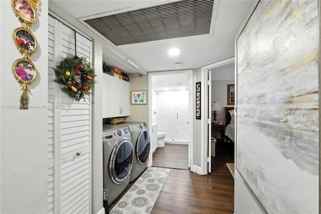 1651 SW 127th Ave Unit 301A, Pembroke Pines, FL 33027 - washroom with washing machine and clothes dryer, cabinet space, and dark wood-style flooring