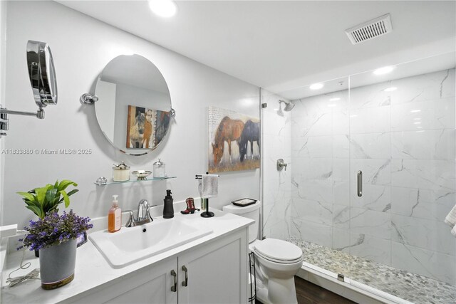 1651 SW 127th Ave Unit 301A, Pembroke Pines, FL 33027 - bathroom featuring a marble finish shower, vanity, recessed lighting, and wood finished floors