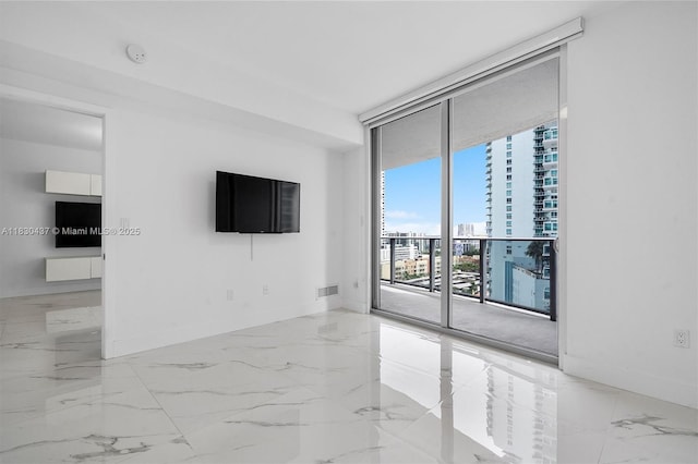 488 NE 18th St Unit 1503, Miami, FL 33132 - empty room featuring marble tiled floors, a wall of windows, and a smoke detector