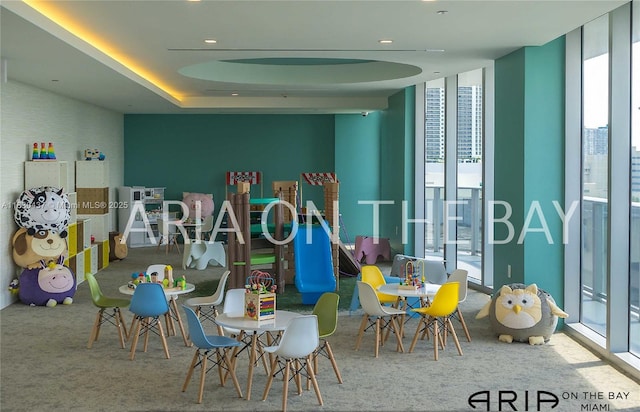 488 NE 18th St Unit 1503, Miami, FL 33132 - rec room with floor to ceiling windows, carpet, and a tray ceiling