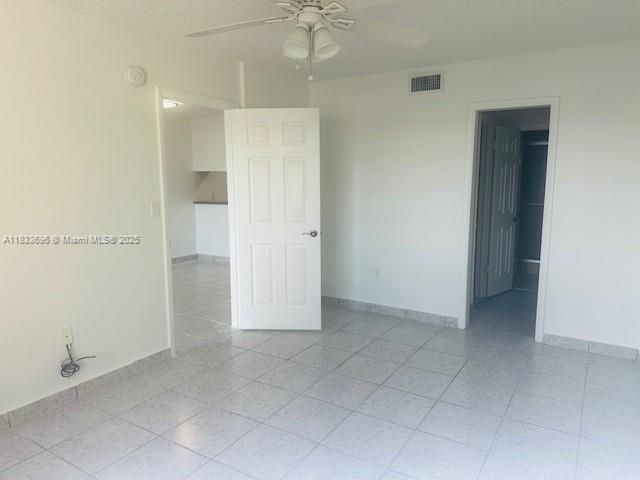 3181 SW 13th St Unit 307, Miami, FL 33145 - empty room with a ceiling fan and light tile patterned floors