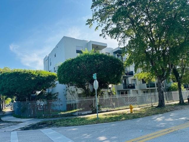 3181 SW 13th St Unit 307, Miami, FL 33145 - view of building exterior featuring a fenced front yard