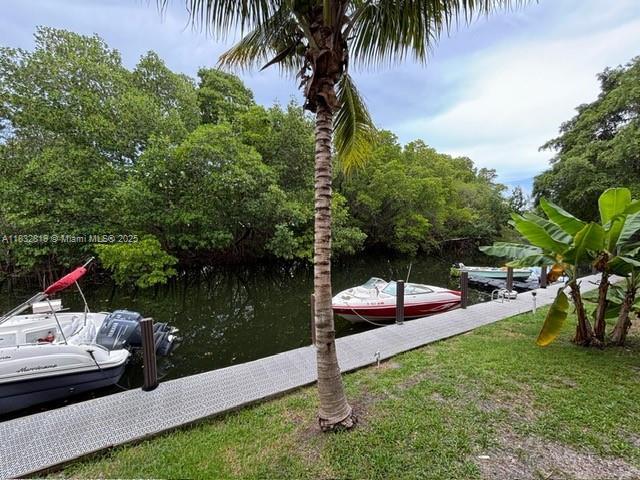 1860 Venice Park Dr Unit 110, North Miami, FL 33181 - dock featuring a water view and a lawn