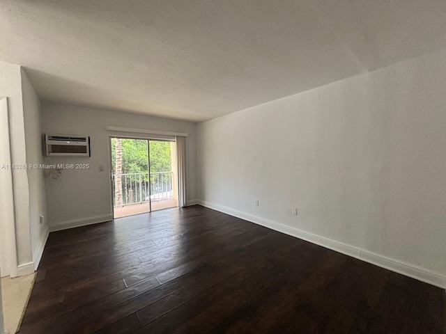 1860 Venice Park Dr Unit 110, North Miami, FL 33181 - spare room with dark wood-style flooring and a wall mounted AC