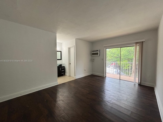 1860 Venice Park Dr Unit 110, North Miami, FL 33181 - unfurnished room with a wall unit AC and wood-type flooring