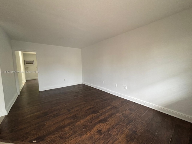 1860 Venice Park Dr Unit 110, North Miami, FL 33181 - empty room with dark wood-style flooring and an AC wall unit