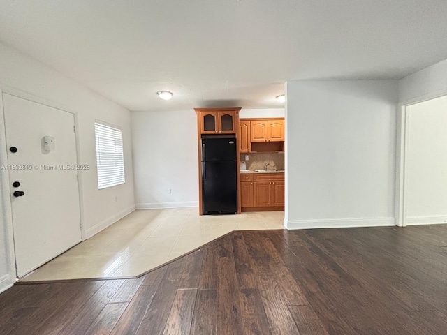 1860 Venice Park Dr Unit 110, North Miami, FL 33181 - unfurnished living room featuring light wood-style floors and a sink