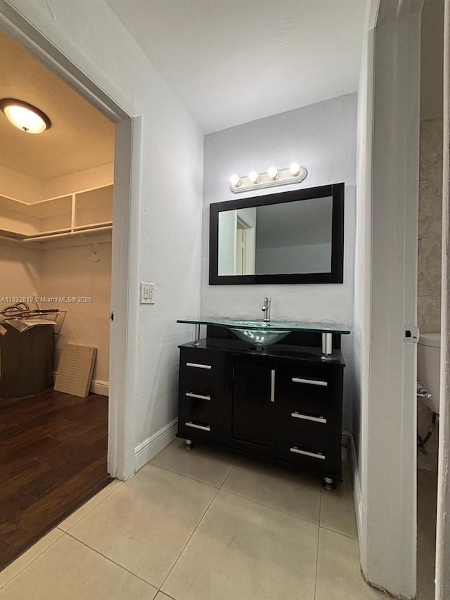 1860 Venice Park Dr Unit 110, North Miami, FL 33181 - bathroom featuring tile patterned floors, vanity, and a walk in closet